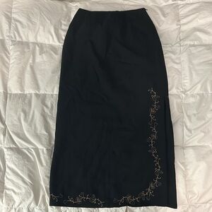 Black Maxi Skirt with Thigh Slit on side. Comes with Embroidered Flower Design.